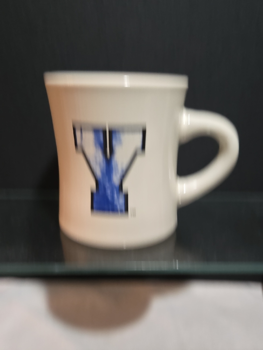 White Ceramic Mug with Blue 'Y' Logo